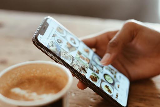 A persons thumb scrolling a social media platform.