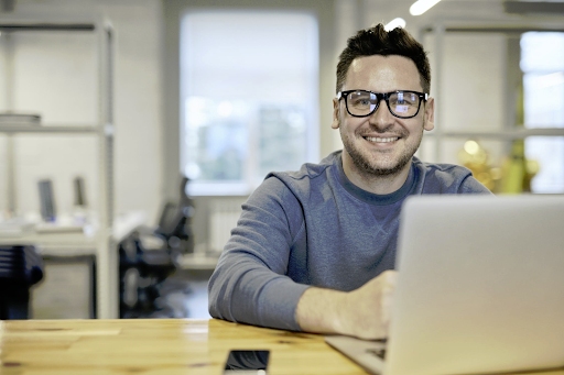 An employee working remotely on his laptop.